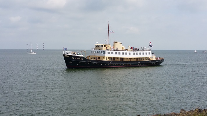 Wandelen over het Groot Frieslandpad bij een rondvaartboot op het IJsselmeer in Medemblik