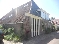 Wandelen over het Groot Frieslandpad bij boerderij in Hindeloopen